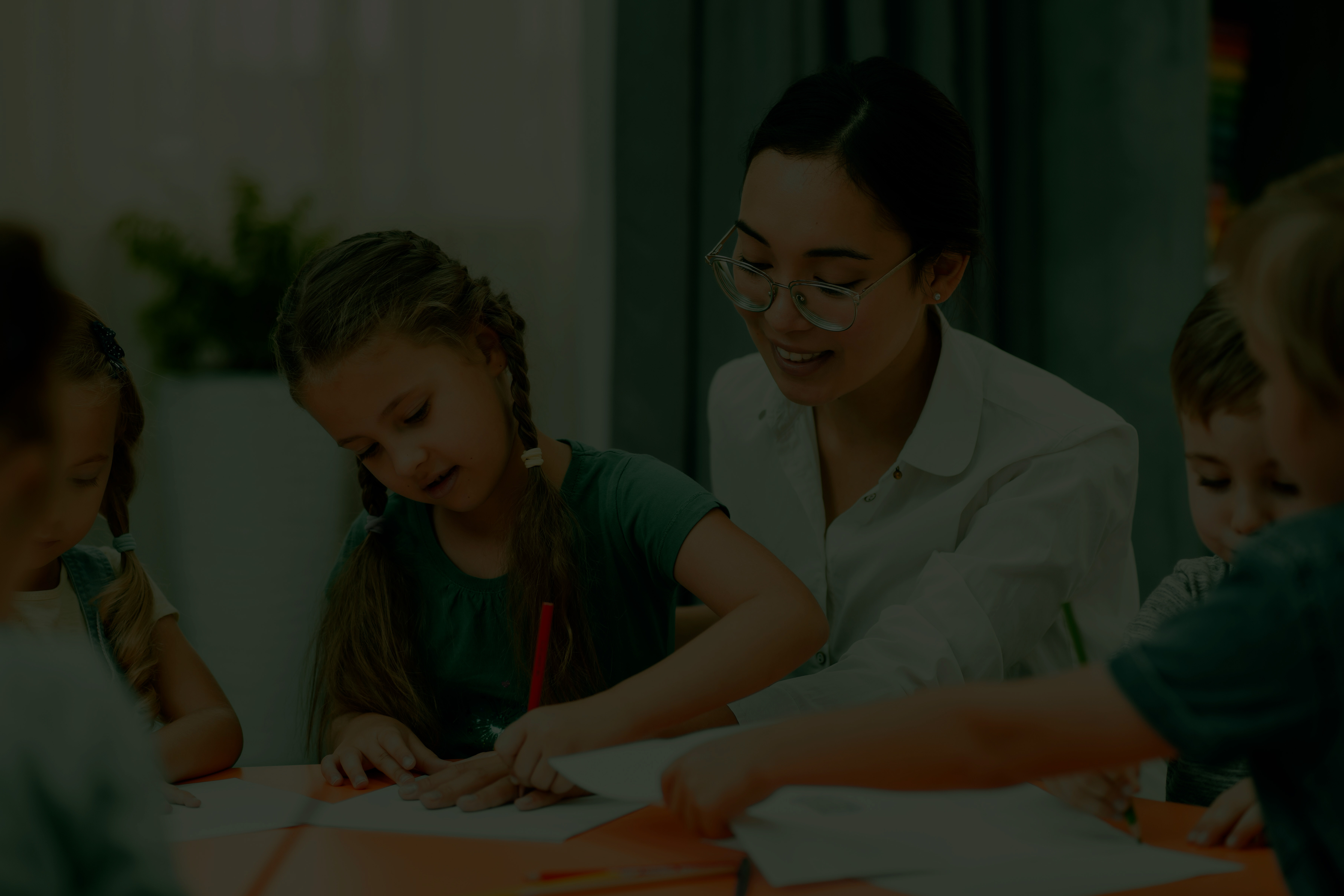 young-teacher-helping-her-students-class(1)ss